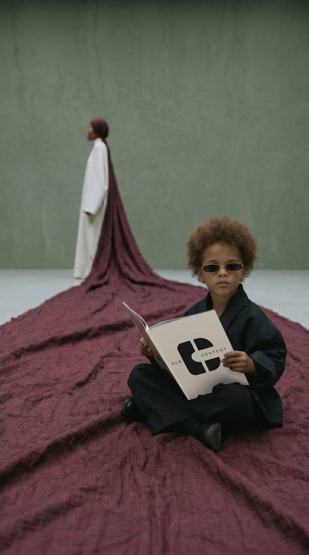 Editorial campaign still with a kid reading a brand book
